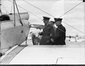 Three RAAF officers inspecting a Gypsy Moth