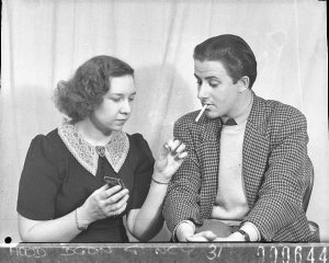 An actress lighting an actor's cigarette (scene from "T...