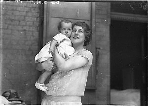 Musical comedy star Dorothy Brunton holding a small chi...