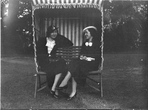 Two women resting at a charity fair. Fete at Miss Fairf...