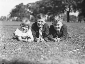 Three young children from Neutral Bay lying on the gras...