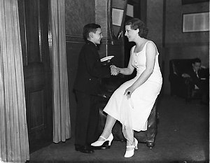 Actress and Young Australia League boy shaking hands