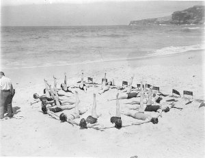 Capitol Theatre chorus girls lie on the sand making a c...