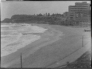Deserted Newcastle Beach, with Royal Newcastle Hospital...