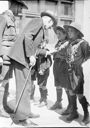 An unidentified VIP inspects some boy scouts at Yass