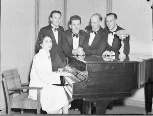 Entertainers around a piano
