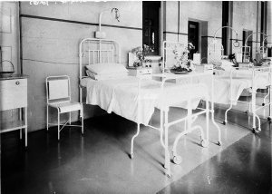 Hospital ward, foreground showing a bed dedicated by HC...