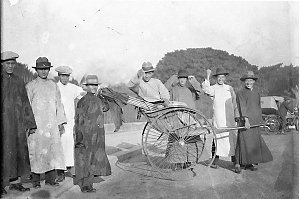Chinese dignitaries in rickshaw