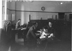 Charles Parsons' company secretary in his office with h...