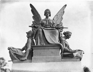 Carved stone figures of a soldier, an angel and a scrib...