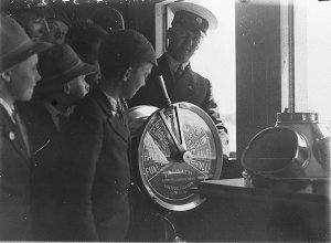 Boys look at engine telegraph on ferry