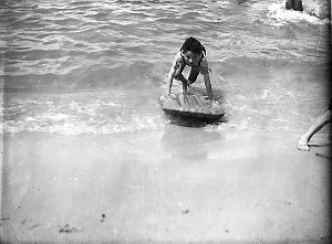 A child with a rubber float in the surf
