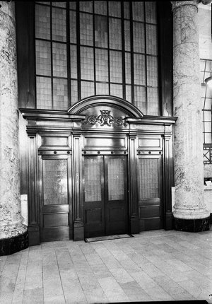 Marble columns beside the wooden entrance doors to Comm...