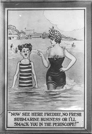 Young woman says to young man bathing in the sea with h...