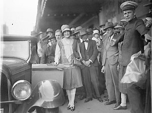 Haymarket Theatre commissionaire holds back the crowd a...