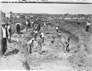 Depression years; relief workers digging a storm-water ...