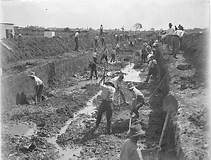 Depression relief workers digging a stormwater canal