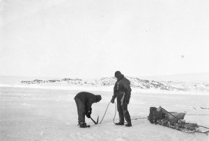 Q634: Dredging on bay ice, making trench for hauling ro...