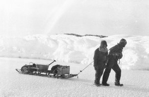 Q624: Hunter and Madigan dragging sledge over bay ice a...