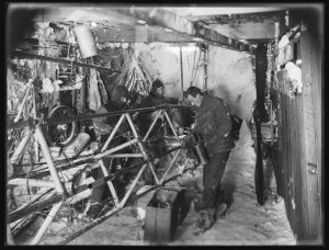 W049: Bickerton repairs the air-tractor in the hangar. ...