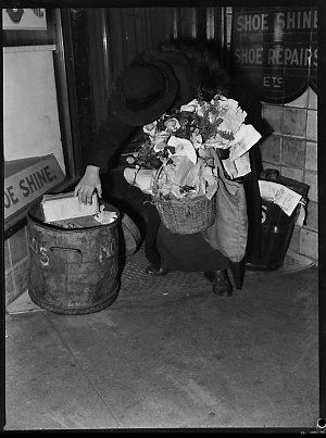 Woman going through garbage tin, July 1946 / photograph...