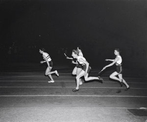 Betty Cuthbert about to take the baton from Fleur Mello...