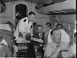 Flight steward serves drinks on the first BOAC Comet 4 ...