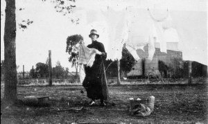 Woman hanging out the washing at 'The Retreat' - Inscri...