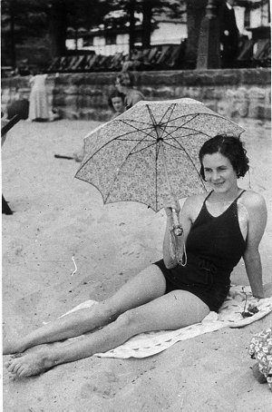 Woman with parasol on beach - Manly, NSW