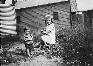 Girl on tricycle in background - Wagga Wagga, NSW