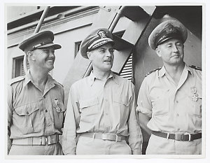 Major James T. Throsby, A.I.F. of Sydney (left) and Lieutenant Eric M. Howitt RANVR, formerly of Rabaul (right) who were awarded the Legion of Merit ... presented on a PT boat by Capt. Selman S. Bowling U.S.N. of New Albany, Indiana, U.S.A. (centre) ...
