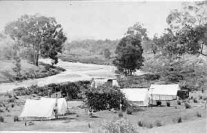 Surveyor's camp on river. Surveyor Arthur Bray on right...