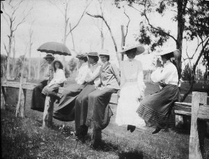 Women spectators seated on fence at "Sandilands" proper...