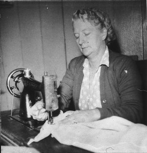 Mrs D. McFaul sewing with Singer treadle machine - sawn...