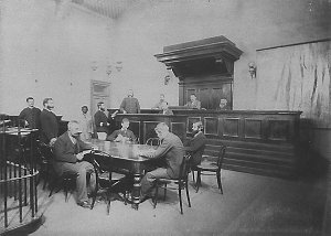 Interior view, showing magistrate, police, clerks - Cob...