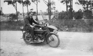 Man on motor-cycle with sidecar.