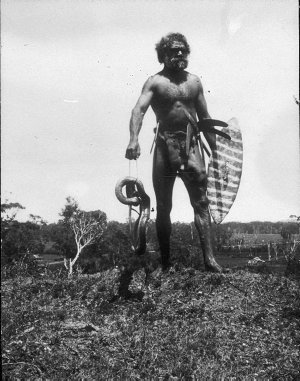 Aborigine with dead snake - Port Macquarie area, NSW