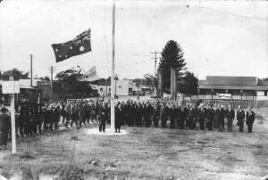 Mrs Charles Sharp unfurling the flag on Anzac Day - Cof...