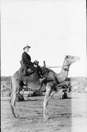 Man posing on camel - Wilcannia, NSW