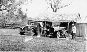Men outside hut with cars - Barrington Tops, NSW