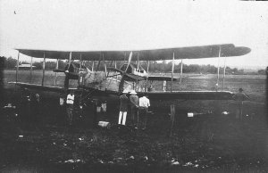 Front view of Vickers Vimy with crew and local official...