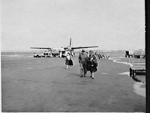 Passengers cross the tarmac after Airlines of NSW Fokke...