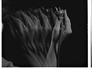 Time-lapse "motion" photograph of hand holding the elec...