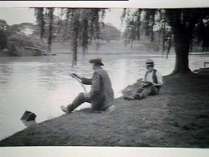 (MM) Two men under a willow tree by a river