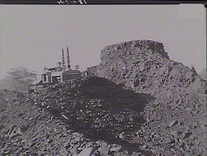 Bulldozers working on coal piles