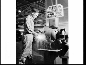 Ford employee working on a grinder without safety goggl...