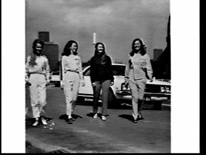 Women's motor racing team in driving suits, day and eve...