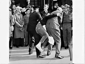 Governor-General Lord Casey reviews a march-past of troops returning from Vietnam and several protesters against the Vietnam War are arrested, Sydney Town Hall