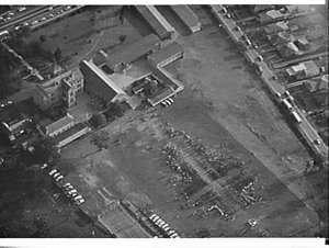 Aerial photographs of Holy Cross College with people ma...