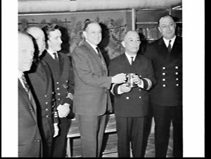 Presentation of a silver tankard to steward Mr. Tam Ker...